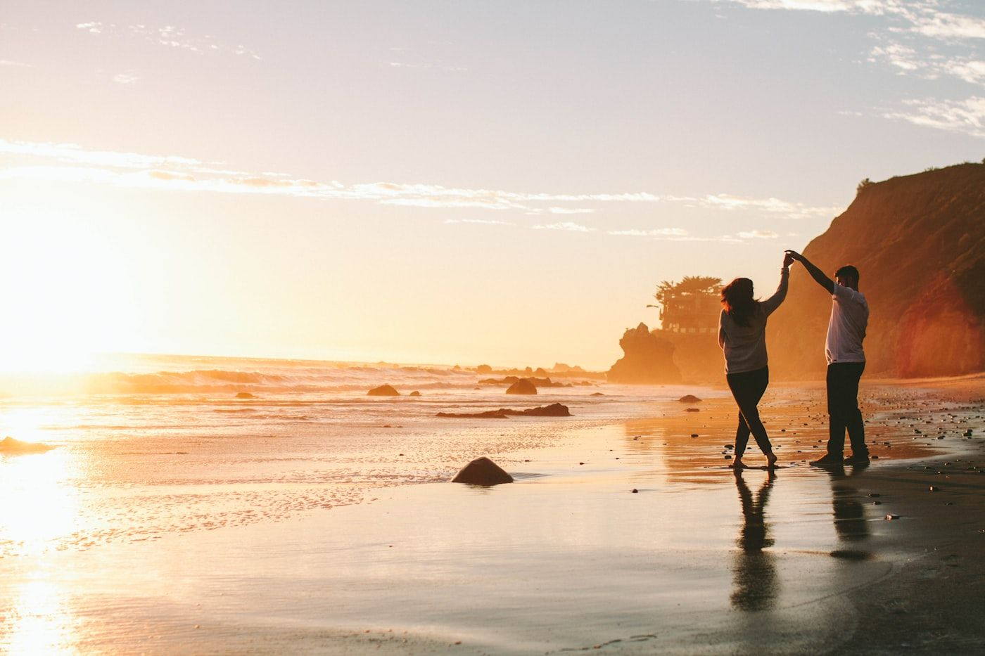 A couple on the shore at sunset